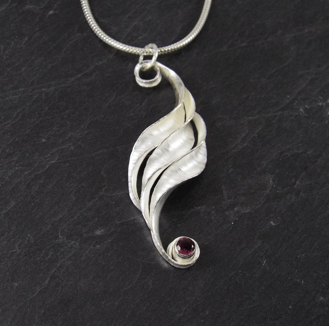 Anne V Massey Jewellery Ripple silver pendant, handmade, with magenta rhodolite garnet January birthstone