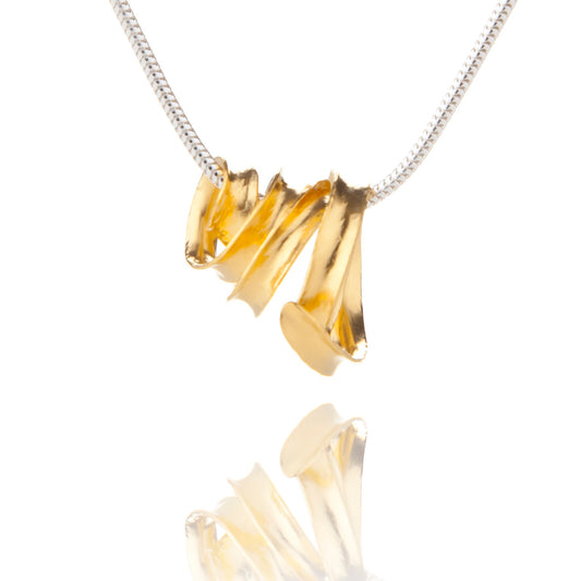 A delicate gold-plated silver ribbon necklace made from a single long strip of sterling silver, formed into a rough spiralling cone, hanging from a silver snake chain.