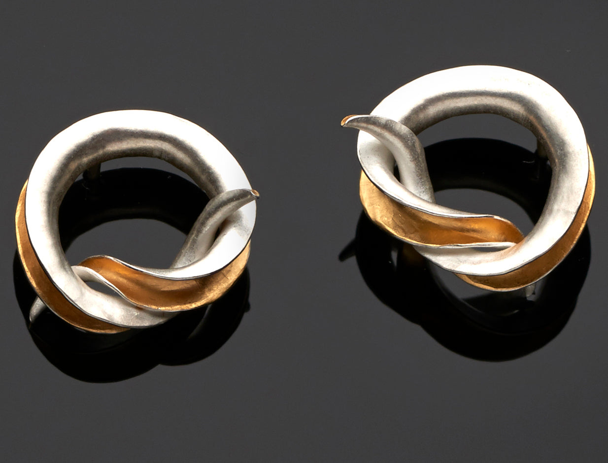 Celebrate tying the knot with a pair of mirror-image stud earrings, each in the form of an open-sided tube tied into a simple knot, gold plated on the inner surface.