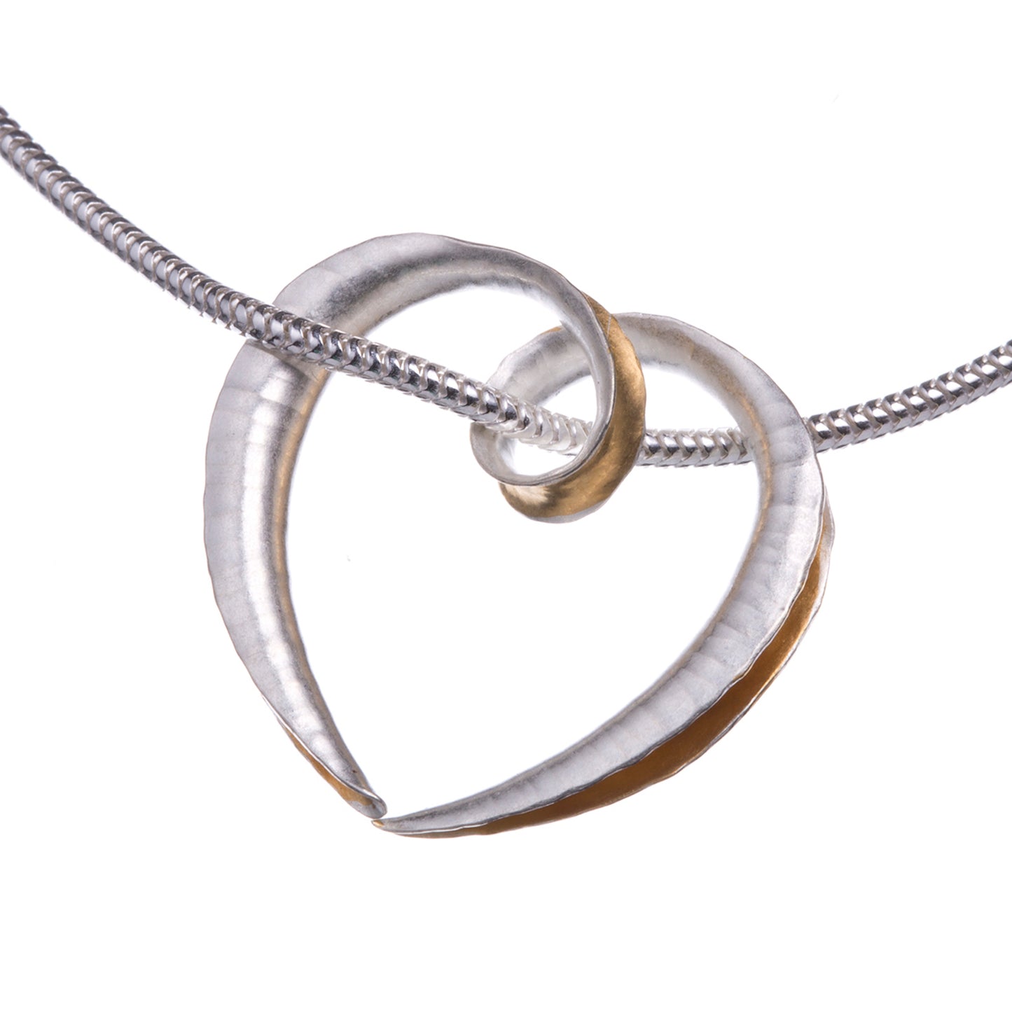 A small silver heart pendant made from a single piece of metal, formed into a sort of tube with the outer side open and gold plated on the inside surface for contrast. It is formed into a loop at the top which the chain passes through.